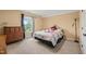 Charming bedroom with a cozy bed, dresser, and a window offering natural light and outside views at 216 Tarkenton Ct, Clayton, NC 27527