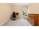 Neutral colored bedroom featuring a desk, chair, dresser and window bringing in natural light at 216 Tarkenton Ct, Clayton, NC 27527