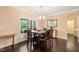 Formal dining room showcasing a dark wood table set, chandelier lighting, and large window for natural light at 216 Tarkenton Ct, Clayton, NC 27527