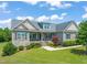 Charming home with stone accents, lush landscaping, and a covered front porch, perfect for enjoying the outdoors at 216 Tarkenton Ct, Clayton, NC 27527