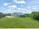 Large green lawn with home including a screened-in porch and three-car garage at 216 Tarkenton Ct, Clayton, NC 27527