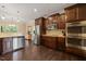 Well-equipped kitchen with stainless steel appliances, rich wood cabinetry, granite countertops, and modern lighting at 216 Tarkenton Ct, Clayton, NC 27527