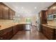 Gourmet kitchen boasts custom cabinetry, stainless steel appliances, granite countertops, and hardwood floors at 216 Tarkenton Ct, Clayton, NC 27527