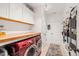 Well-organized laundry room with red washer and dryer, storage cabinets, and a convenient folding area at 216 Tarkenton Ct, Clayton, NC 27527