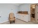 Living room with a rocking chair with a beverage center including wine storage to the right at 216 Tarkenton Ct, Clayton, NC 27527