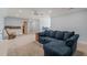Spacious living room with plush seating, soft lighting, and direct access to the outdoor patio area at 216 Tarkenton Ct, Clayton, NC 27527