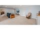 Bright living room with blue walls featuring a sofa, TV, wooden cabinet and rocking chair at 216 Tarkenton Ct, Clayton, NC 27527