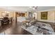 Open-concept living room featuring hardwood floors, elegant furnishings, and a seamless flow to the kitchen at 216 Tarkenton Ct, Clayton, NC 27527