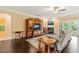 Cozy living room with a fireplace, hardwood floors, and a large TV, perfect for relaxation and entertainment at 216 Tarkenton Ct, Clayton, NC 27527