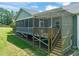 Comfortable screened porch with wooden pergola overlooking the backyard at 216 Tarkenton Ct, Clayton, NC 27527