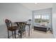 Cozy sitting area with a bar height table, decorative chairs and window with a view of the community at 216 Tarkenton Ct, Clayton, NC 27527