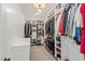 Organized walk-in closet featuring custom shelving, ample storage space, and a central chandelier for lighting at 216 Tarkenton Ct, Clayton, NC 27527