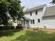 Exterior view of a home with a screened-in porch overlooking a large backyard with green grass at 2208 Fieldmont Ct, Raleigh, NC 27614