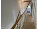 Upstairs hallway with white walls, wood trim and carpeted floors at 2208 Fieldmont Ct, Raleigh, NC 27614