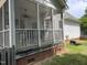 Cozy screened-in porch with ceiling fan, railing, and access to a spacious backyard at 2208 Fieldmont Ct, Raleigh, NC 27614