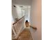 Interior stairway featuring unfinished wood steps, white railings, and a pendant light fixture at 2208 Fieldmont Ct, Raleigh, NC 27614