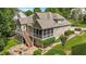 Aerial view of a lovely home featuring a deck, screened in porch, patio, and manicured lawn in a lush, green neighborhood at 224 Midden Way, Holly Springs, NC 27540