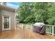 Back deck features grill and wooded view at 224 Midden Way, Holly Springs, NC 27540