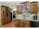 Basement bar area with custom cabinetry, granite countertops and a built-in wine rack at 224 Midden Way, Holly Springs, NC 27540