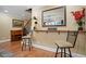 Finished basement features a bar with seating, a piano, and access to the staircase with decorative iron railings at 224 Midden Way, Holly Springs, NC 27540