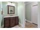 Bathroom features a granite countertop, ample cabinet space, and a decorative mirror at 224 Midden Way, Holly Springs, NC 27540