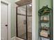 Bright bathroom featuring a tiled shower with a glass door and a built-in seat at 224 Midden Way, Holly Springs, NC 27540