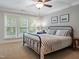 Bright bedroom features a comfortable bed, large windows and neutral paint at 224 Midden Way, Holly Springs, NC 27540