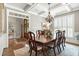 Elegant dining room with coffered ceilings, wood floors, and a chandelier over the dining table at 224 Midden Way, Holly Springs, NC 27540