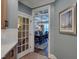 View of dining room featuring table, chairs, chandelier through glass paneled doorway at 224 Midden Way, Holly Springs, NC 27540