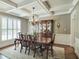 Elegant dining room with coffered ceilings, wood floors, chandelier, and beautiful furniture at 224 Midden Way, Holly Springs, NC 27540