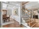 Welcoming foyer showcasing hardwood floors, staircase, and views of the dining room and living room at 224 Midden Way, Holly Springs, NC 27540