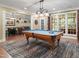 Bright billiard room with large windows and a view of the basement bar area at 224 Midden Way, Holly Springs, NC 27540