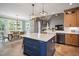 Modern kitchen with a large island, stainless steel appliances, and an eat-in area for casual dining at 224 Midden Way, Holly Springs, NC 27540