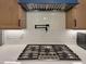 Close-up of a chef's kitchen featuring a pot filler, custom cabinetry, and white subway tile backsplash at 224 Midden Way, Holly Springs, NC 27540