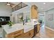 The kitchen features an island, an apron sink, and easy access to the living areas at 224 Midden Way, Holly Springs, NC 27540