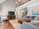 Spacious living room with soaring ceilings, a staircase, and an open floor plan design at 224 Midden Way, Holly Springs, NC 27540