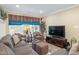 Comfortable living room with plush seating, large windows and a mounted TV at 224 Midden Way, Holly Springs, NC 27540
