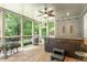 Relaxing screened porch featuring a hot tub, ceiling fan and outdoor seating, ideal for unwinding and enjoying the outdoors at 224 Midden Way, Holly Springs, NC 27540