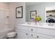 Well-lit bathroom with a double sink vanity, a tub with shower, and closet with washer and dryer at 226 Macon Lake Drive # 41, Apex, NC 27523