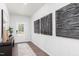Inviting entryway with modern art, wood floors, and decorative wallpaper at 226 Macon Lake Drive # 41, Apex, NC 27523