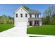 Beautiful white brick two-story home featuring a manicured lawn and an attached two-car garage at 226 Macon Lake Drive # 41, Apex, NC 27523