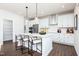 Modern white kitchen with stainless steel appliances and a large island at 226 Macon Lake Drive # 41, Apex, NC 27523