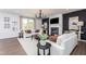 Comfortable living room with fireplace, modern chandelier and stylish decor at 226 Macon Lake Drive # 41, Apex, NC 27523
