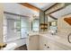 Bathroom features a double sink vanity, a shower behind patterned glass doors at 2631 Harvard Ave, Durham, NC 27703