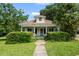 Charming home featuring a covered front porch with manicured landscaping and mature trees at 2631 Harvard Ave, Durham, NC 27703