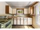 Sunny kitchen boasts ample cabinet space and classic design elements at 2631 Harvard Ave, Durham, NC 27703