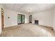 Carpeted living room with fireplace features French doors to adjoining room at 2631 Harvard Ave, Durham, NC 27703