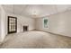 Spacious carpeted living room features a fireplace and large window for natural light at 2631 Harvard Ave, Durham, NC 27703