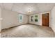 Spacious carpeted living room features multiple windows for natural light at 2631 Harvard Ave, Durham, NC 27703