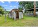 Aged outbuilding with sliding doors and a small window set on a grassy lot at 2631 Harvard Ave, Durham, NC 27703